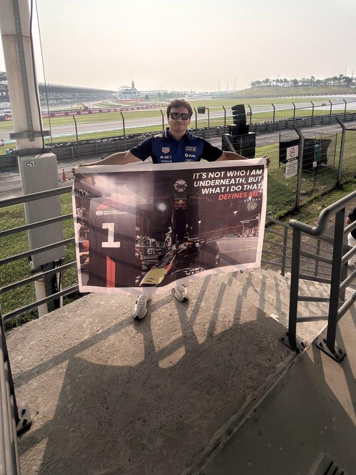 Holding a Max Verstappen banner in the grandstand at Sepang International Circuit