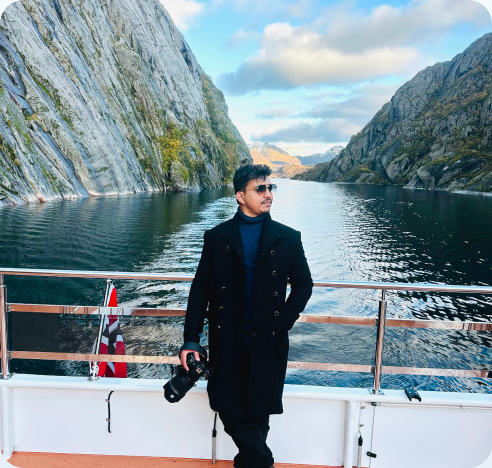 On the deck of a boat sailing through a fjord