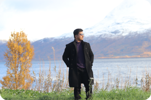 Standing by a mountain lake in an autumn landscape